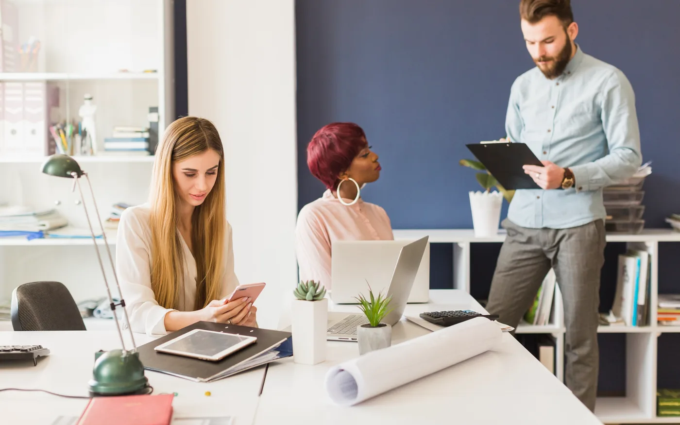 Dealership staff working at desks in an open-plan office